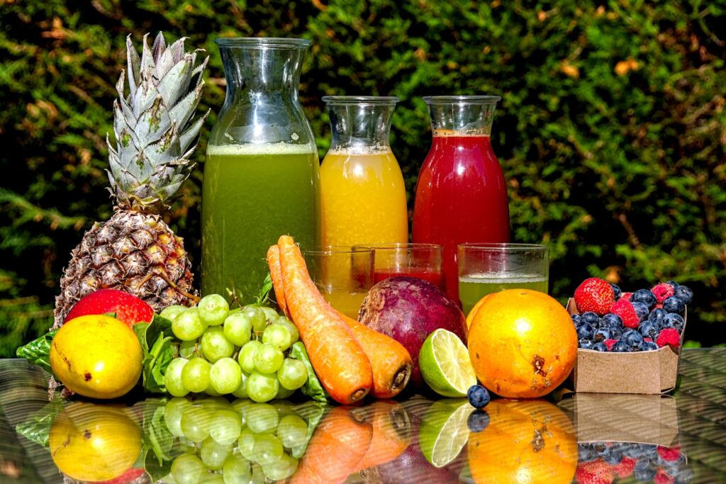 Fruits and vegetables and juices made from them on a table
