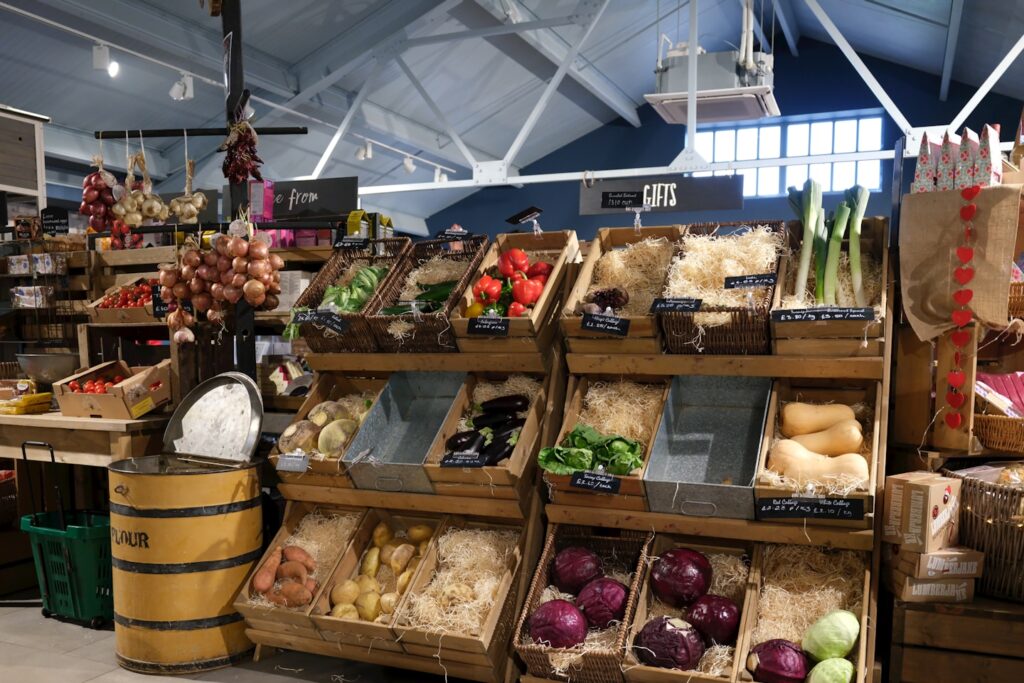 Fresh produce displayed in wooden crates at a market.